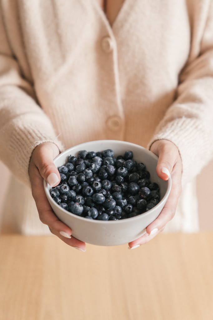 Woman Holding a Bowl of Blueberries